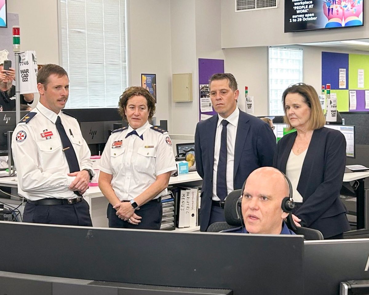 Emergency workers talking with Minister Ryan Park and Anna Watson MP in their control centre.