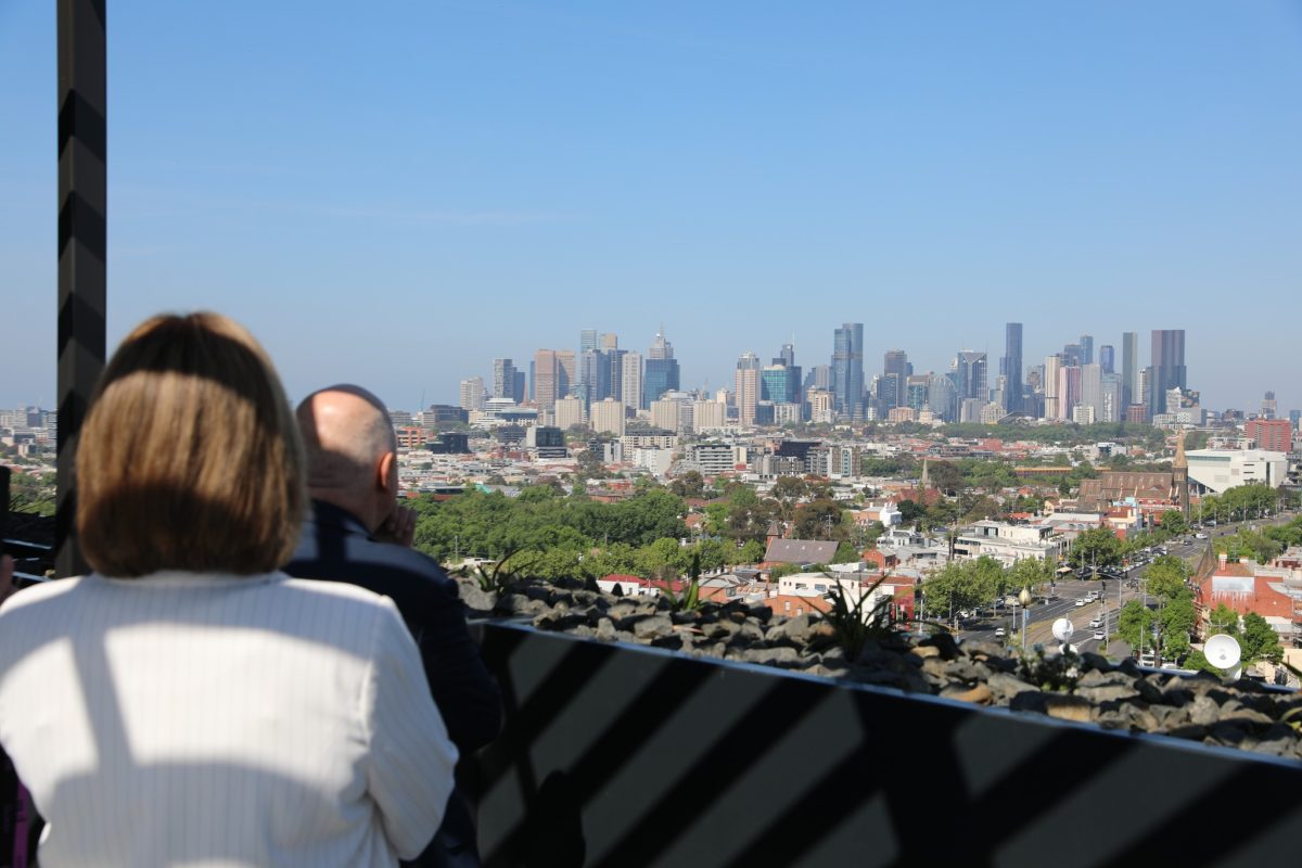 Landscape of Melbourne city with the back of Premier Jacinta Allan and Treasurer Tim Pallas in the foreground.