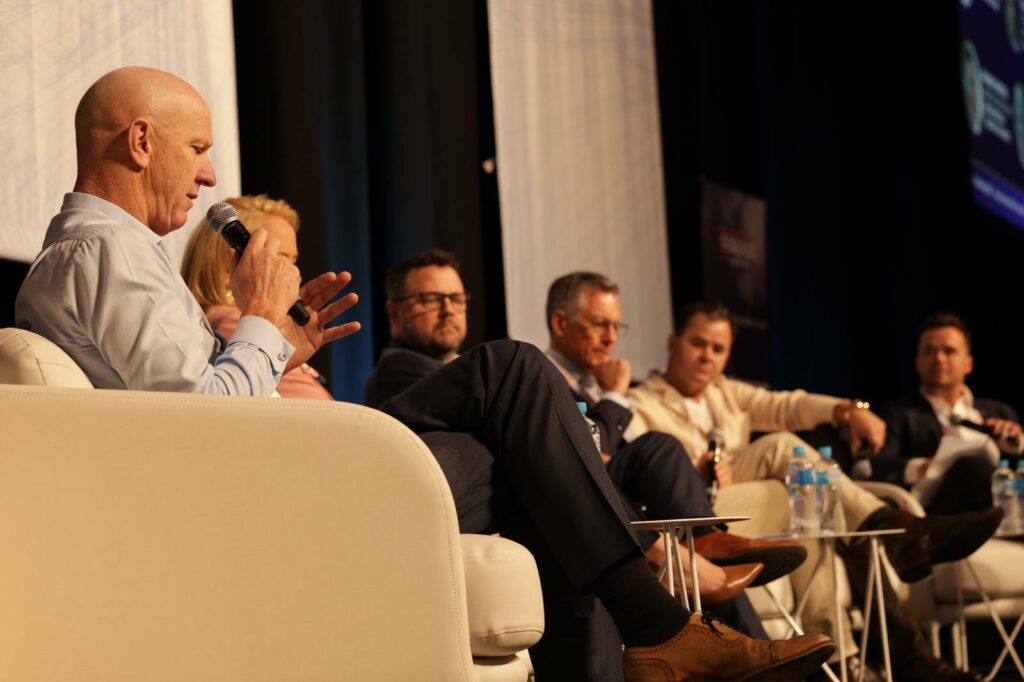 man on stage addressing a seminar 