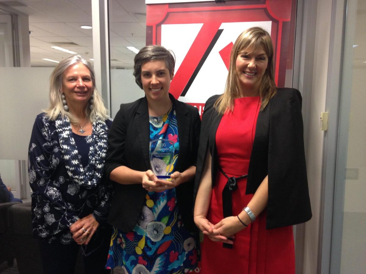 three women standing in an office