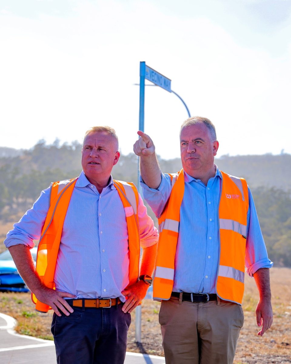 two men in high-vis vests