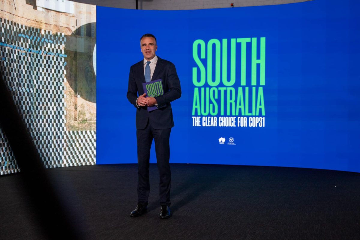 man standing in front of a big screen