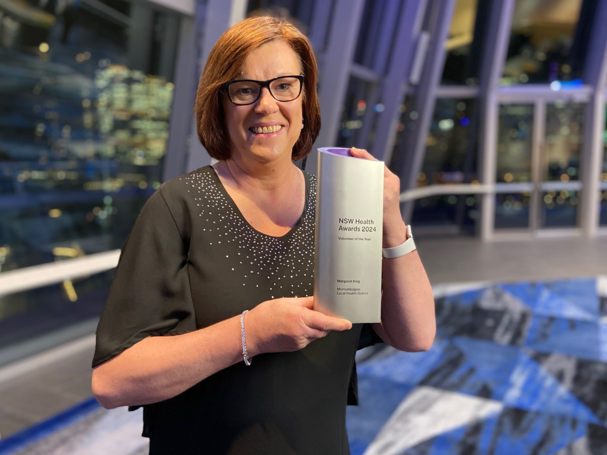 smiling woman with her award