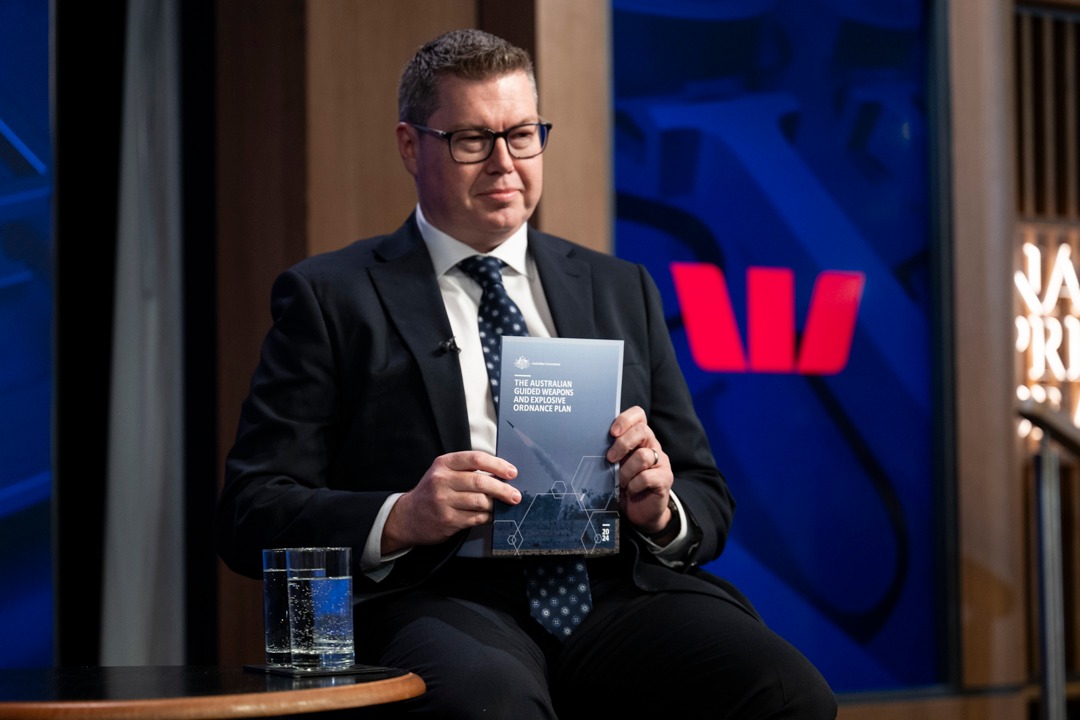 man holding a government booklet