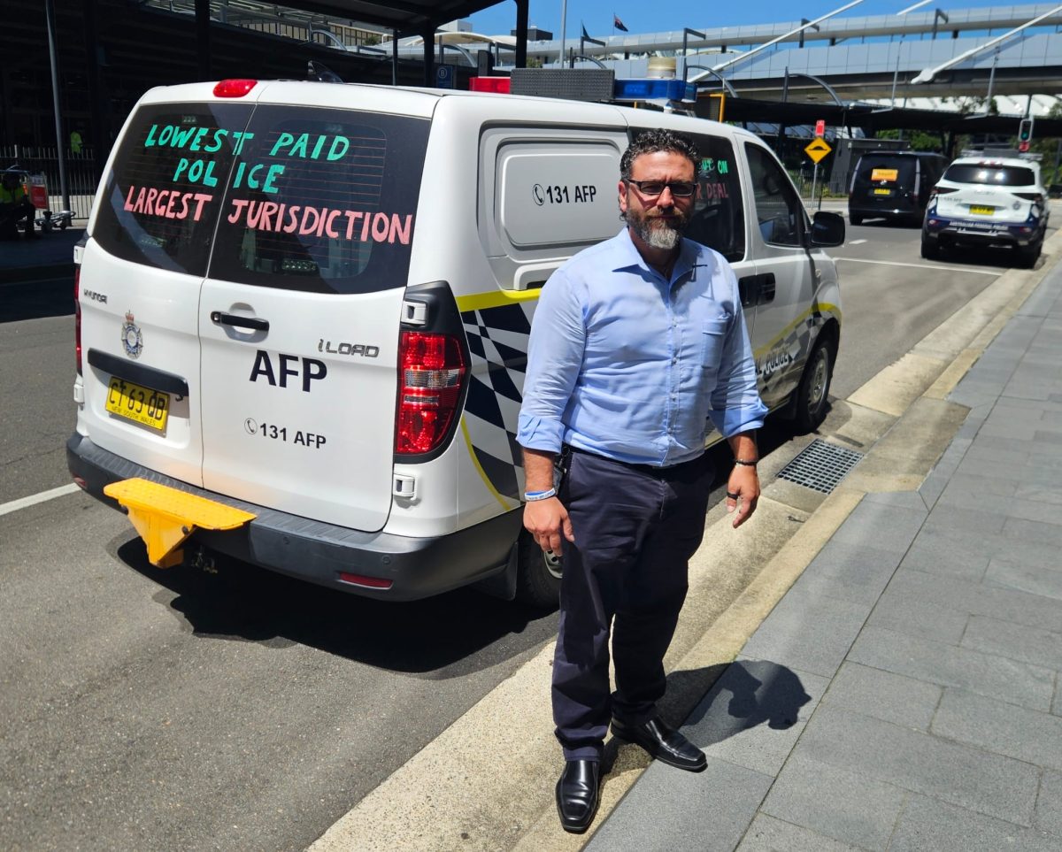 man standing next to a parked van