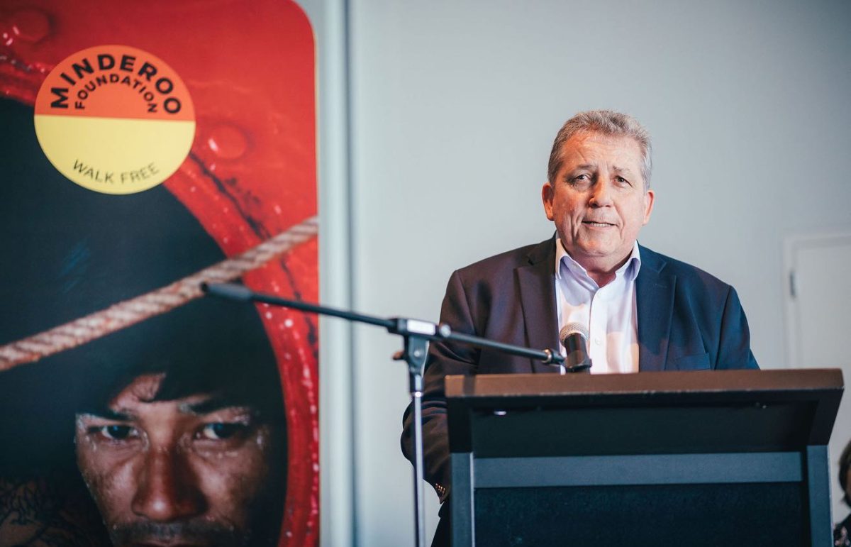 man speaking at a lectern