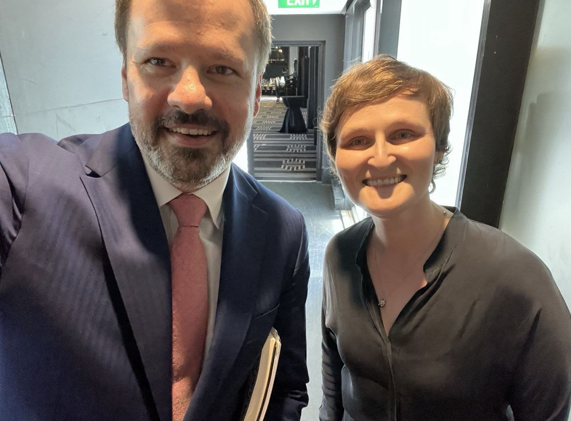 a man and a woman in a selfie in a corridor