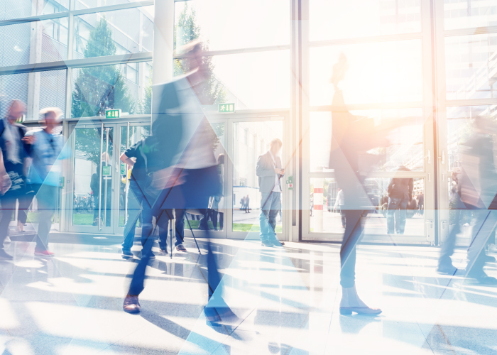 blurred image of people walking inside an office building