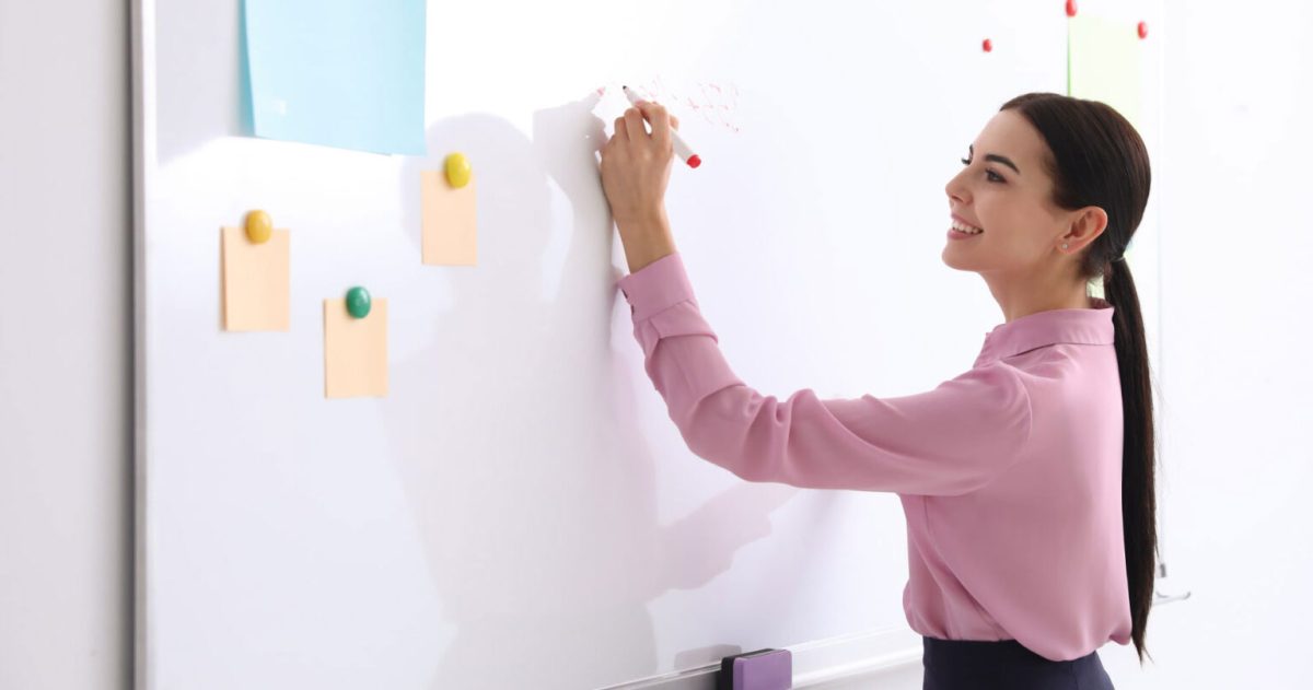 woman writing on whiteboard