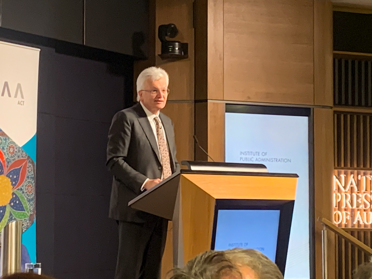 A man speaking from a lectern 