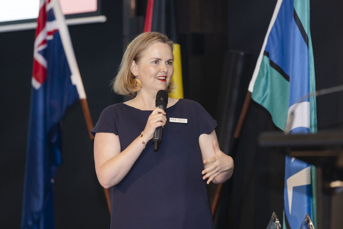 A woman speaking with a microphone in hand