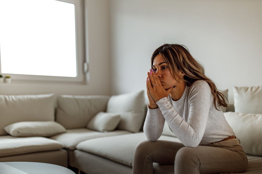 a distressed woman sitting on a couch