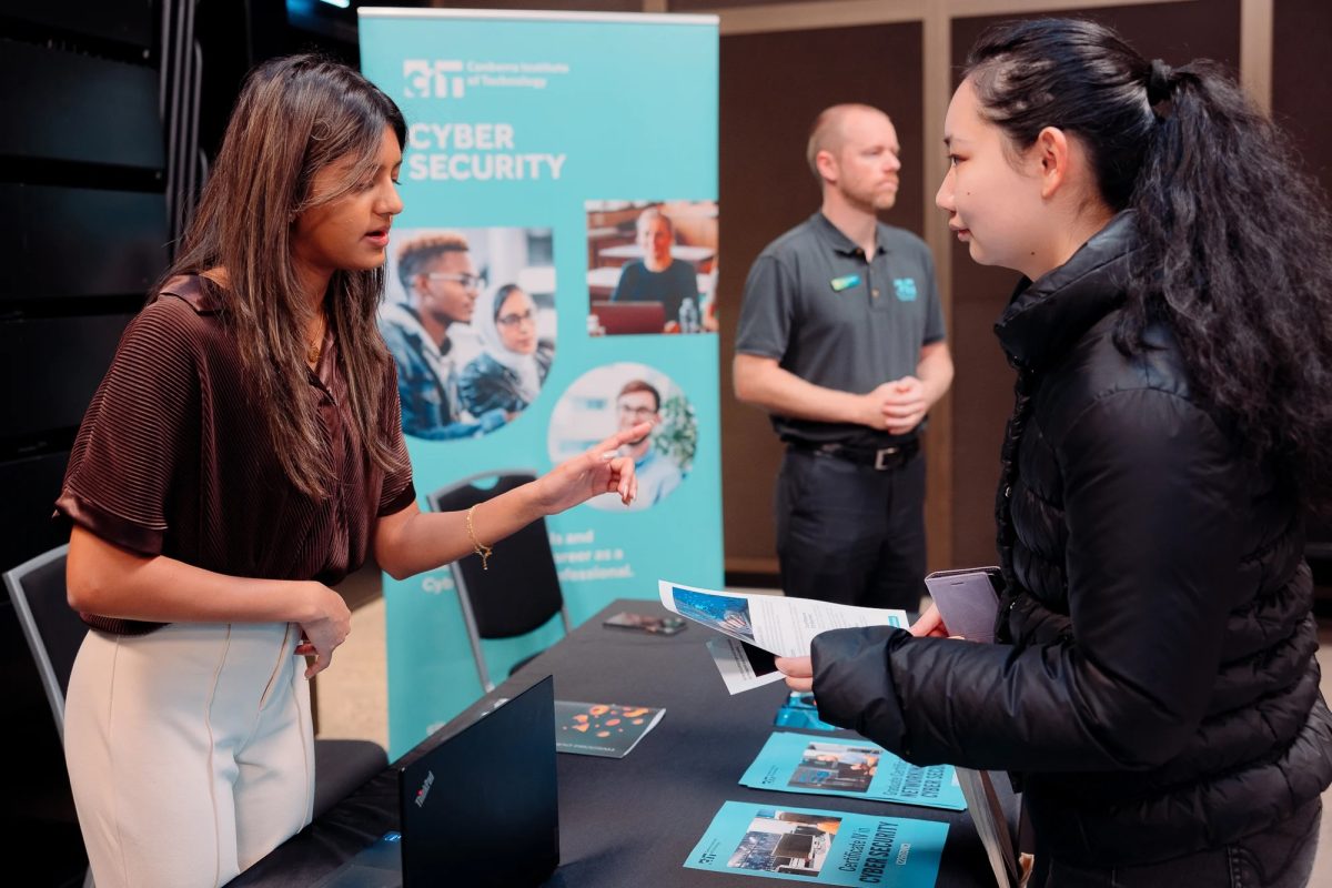 two women in conversation at a seminar counter