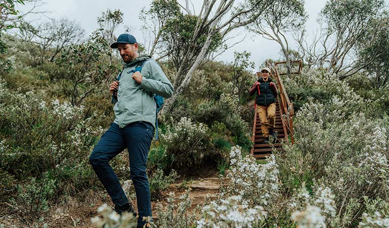 a man and a woman bushwalking