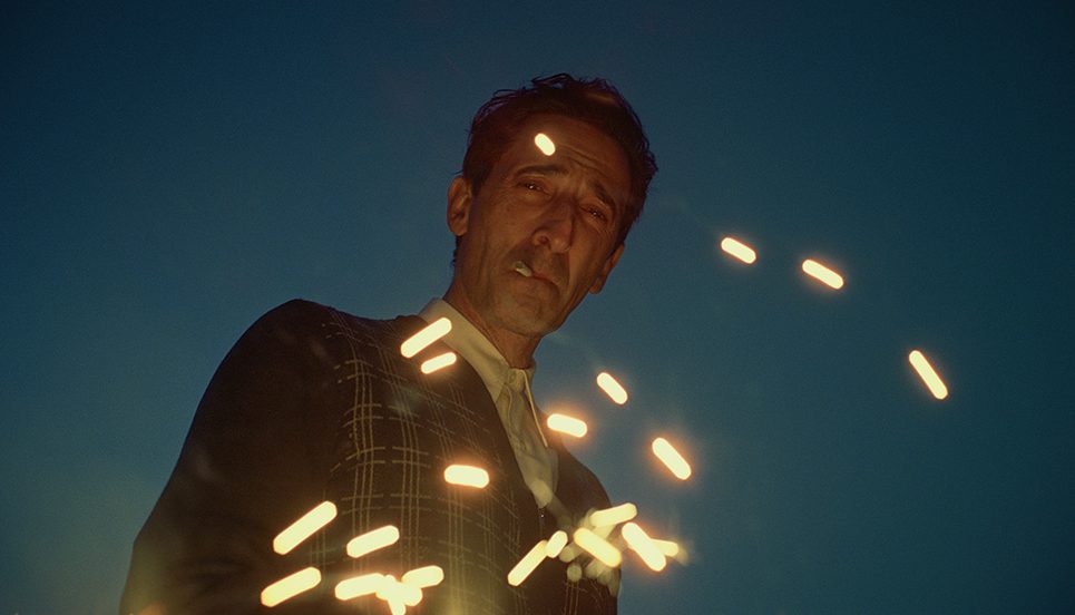 a man with a cigarette in his mouth is surrounded by small bullet-shaped lights