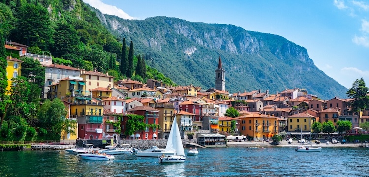 boats on a lake beside a town