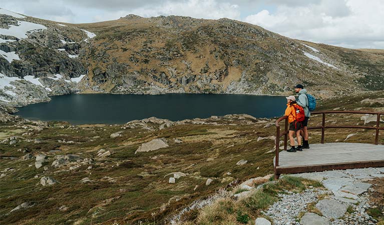 a man and a woman at an alpine lookout