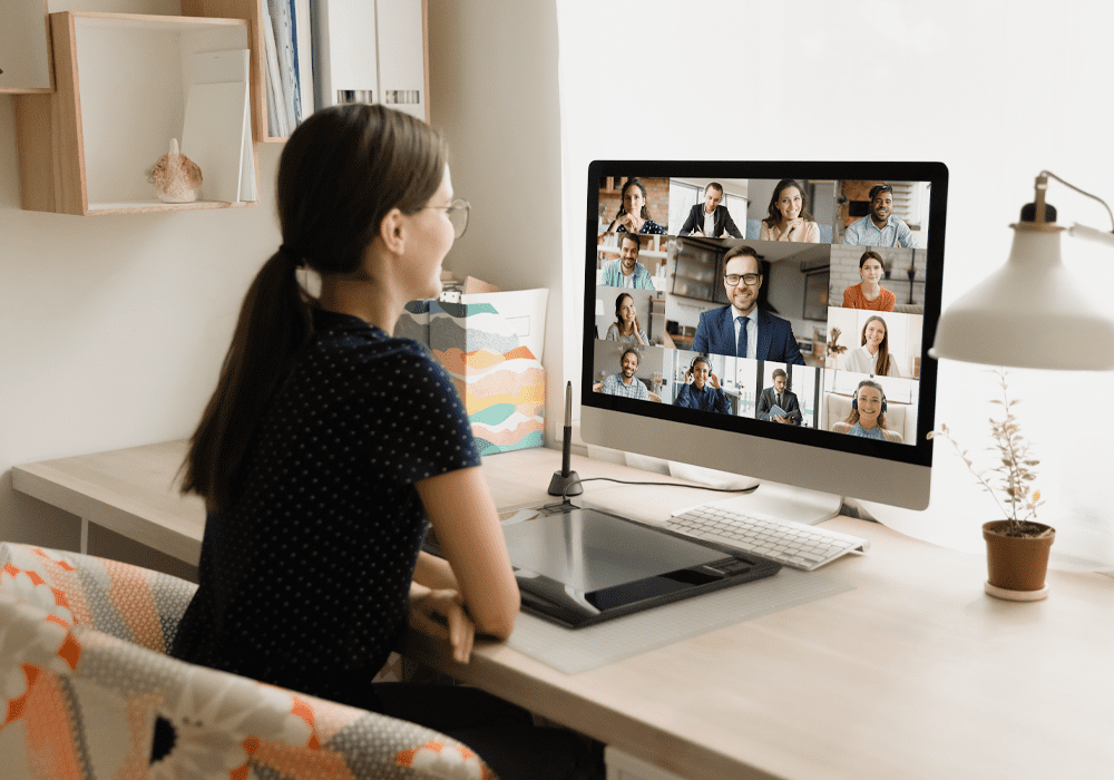 Woman looking at screen with images of colleagues