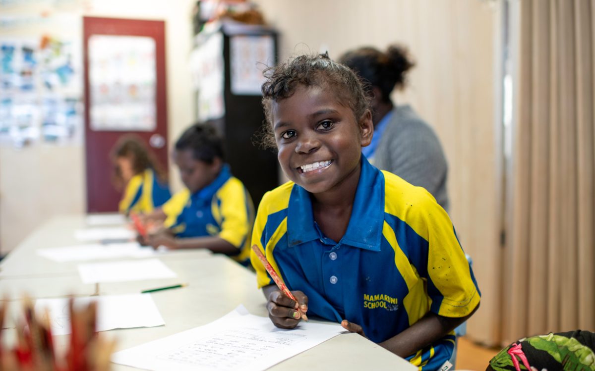 a smiling primary school student in class