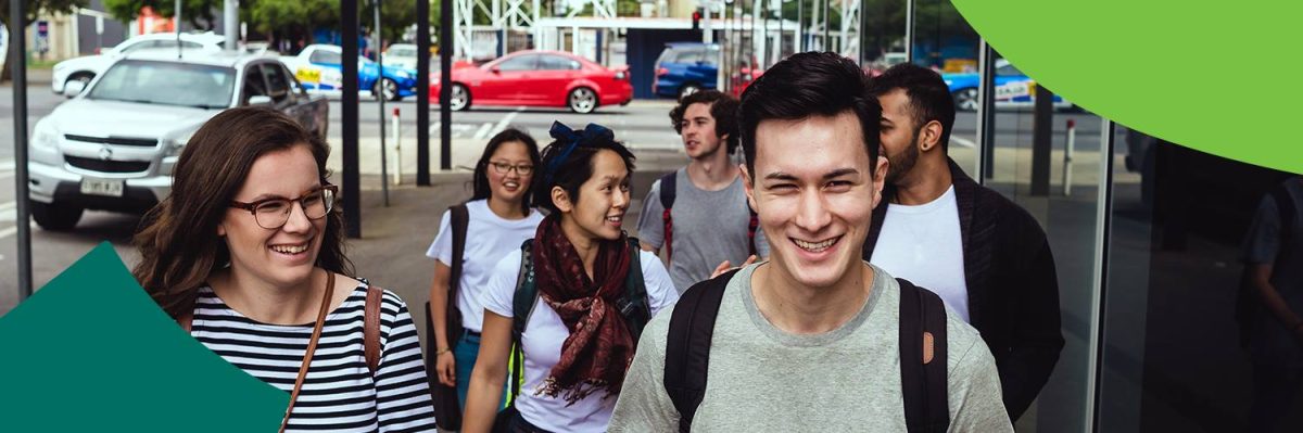 a group of young people walking on a footpath