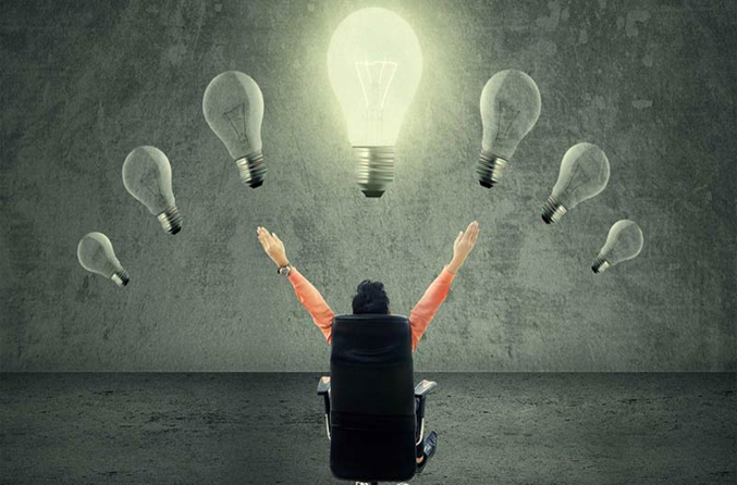 Man looking up at a lightbulb