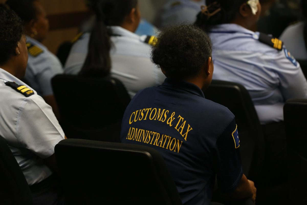 seated women in uniform listening to a presentation 