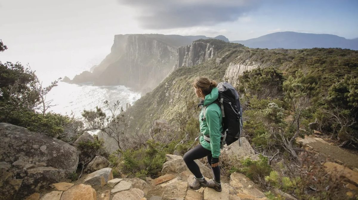 A woman hiking on a coastal track