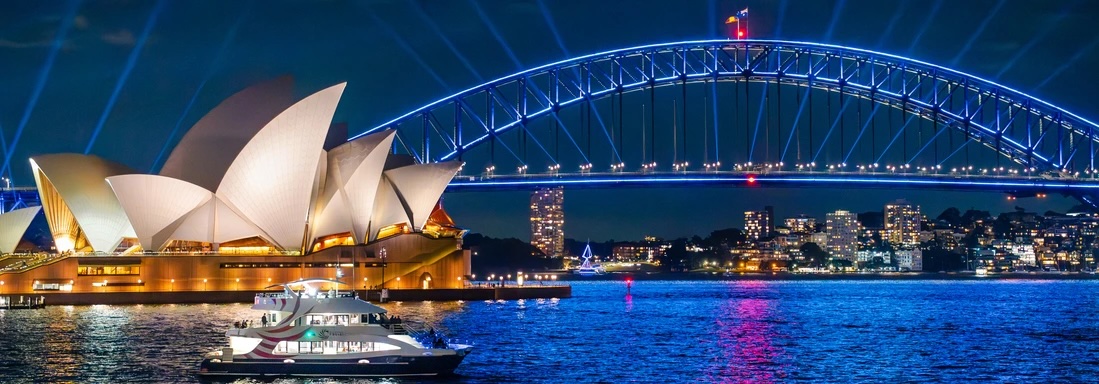 Lit-up Opera House and bridge