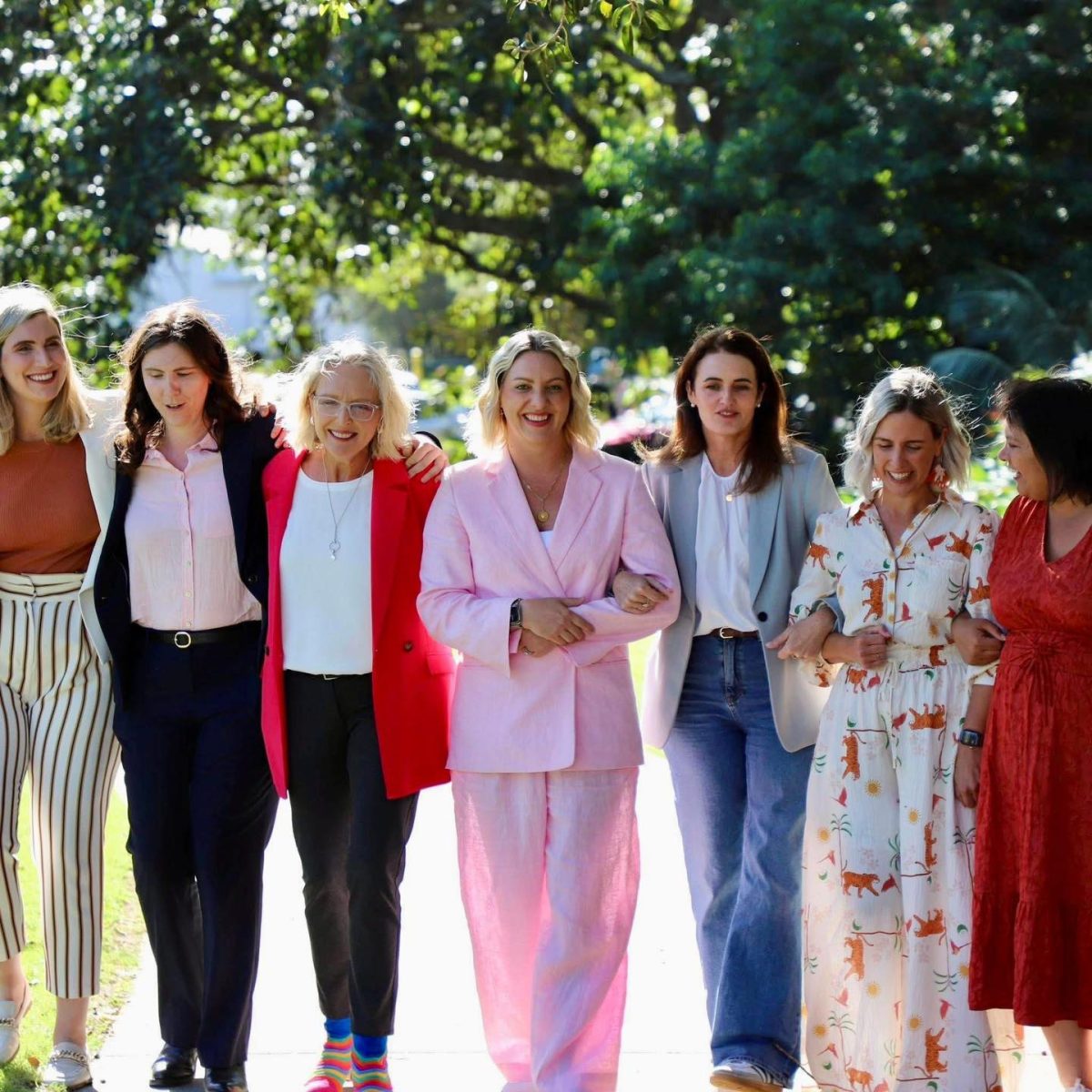 a row of women arm-in-arm