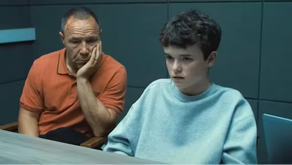father and son sitting in a police interview room