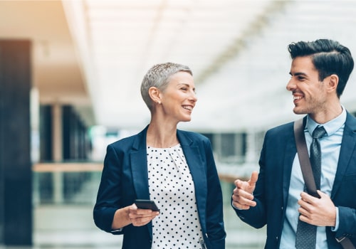 a woman and a man in conversation in an office building