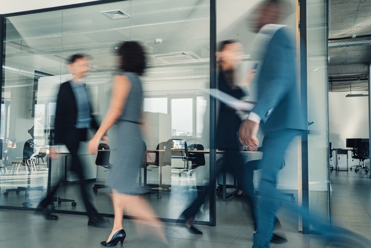 people walking around their office building