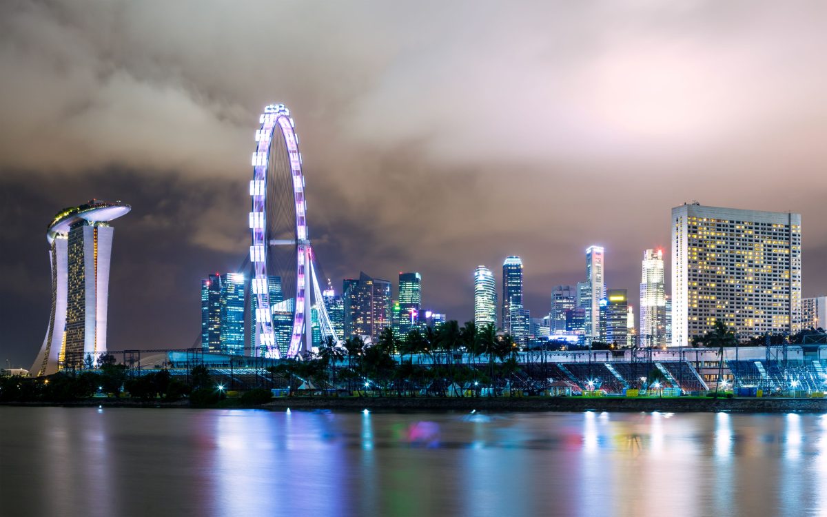 a riverside city skyline by night