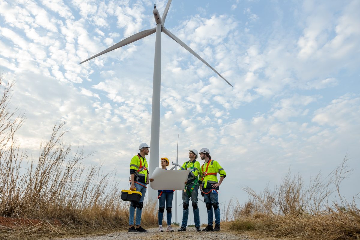 four people in hi-vis gear at a wind farm
