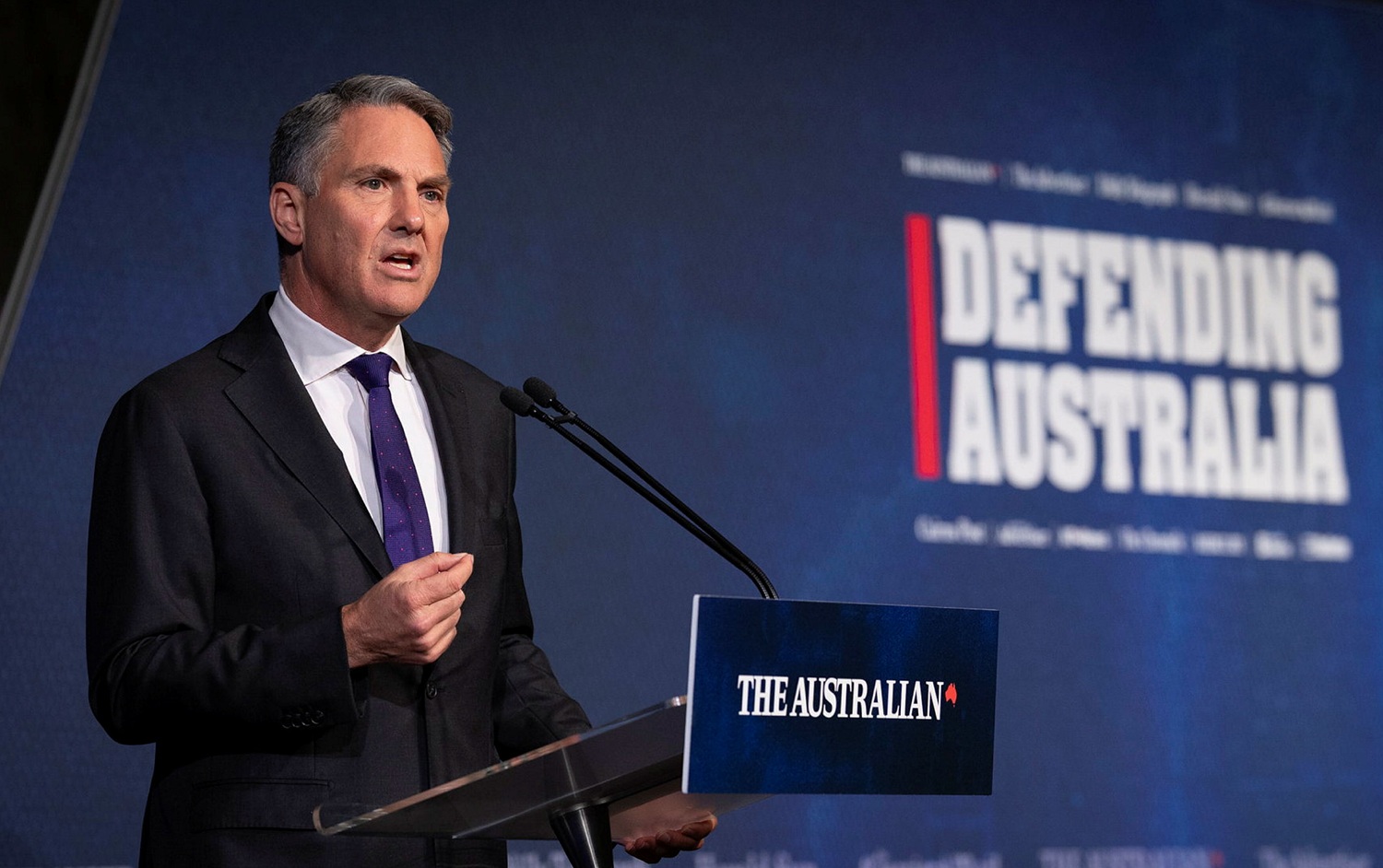 man speaking at lectern