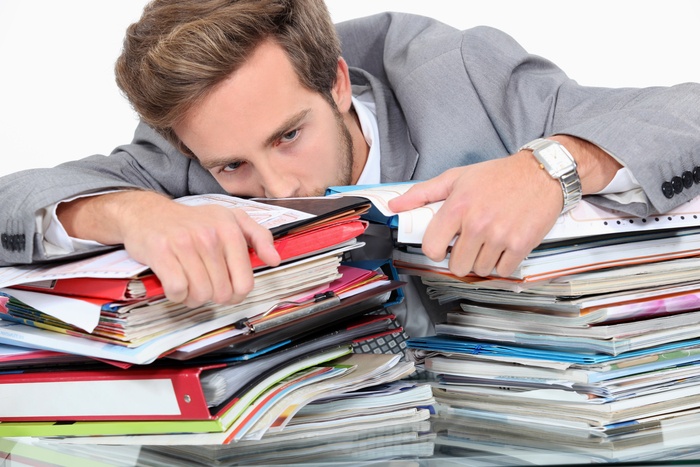 Man with a pile of papers