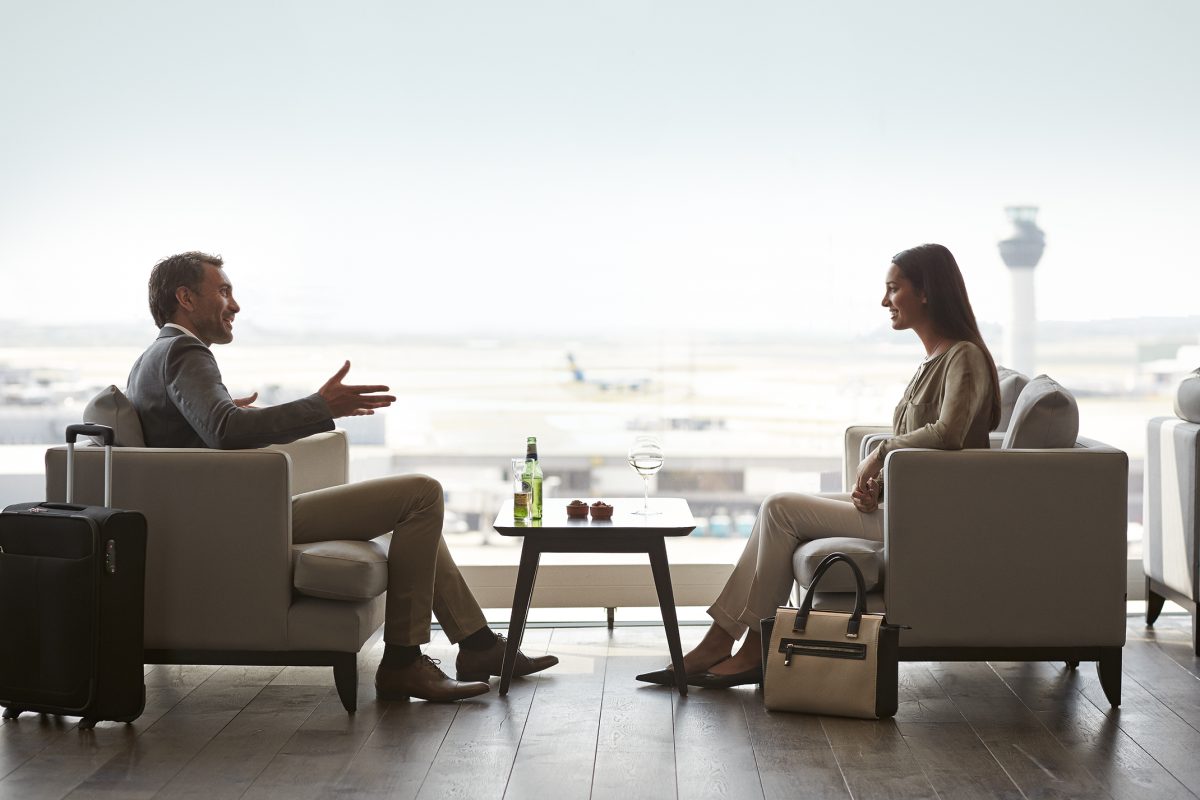 Two people talking in an airport lounge