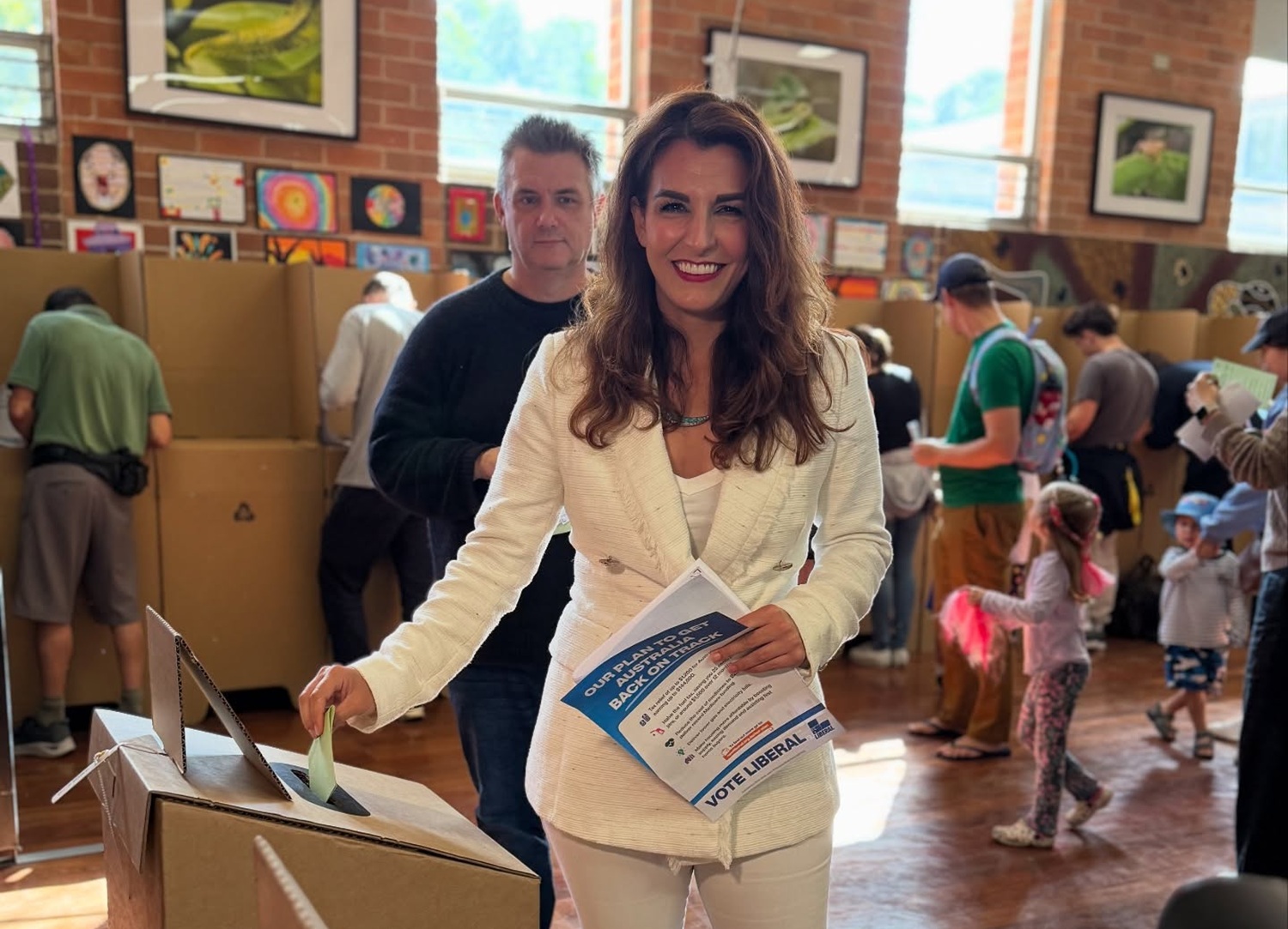 woman placing her vote in a ballot box