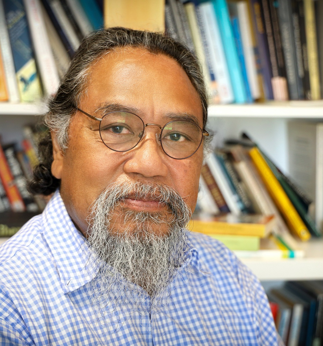 bespectacled man with a grey goatee 