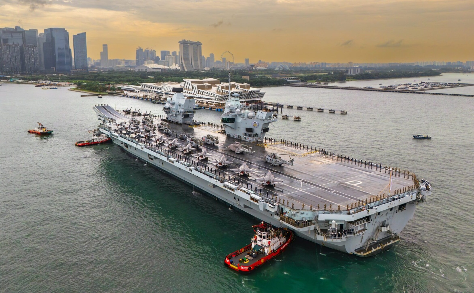 navy aircraft carrier arriving at a port