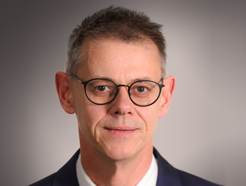 suited man wearing glasses