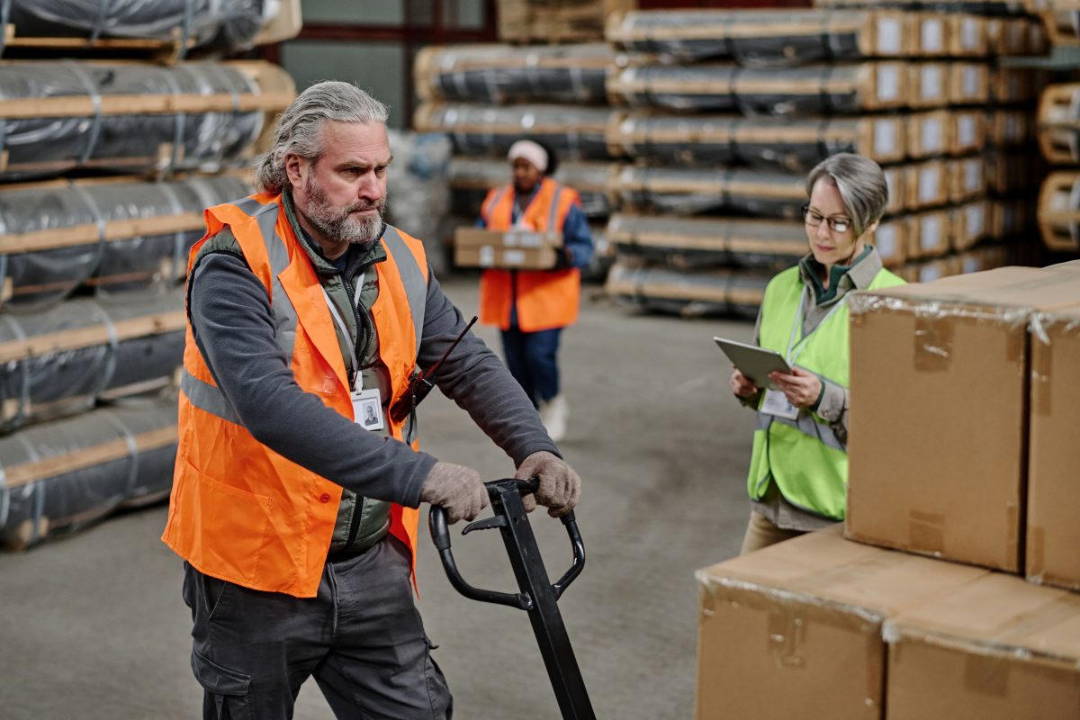 man being supervised while training in warehouse work