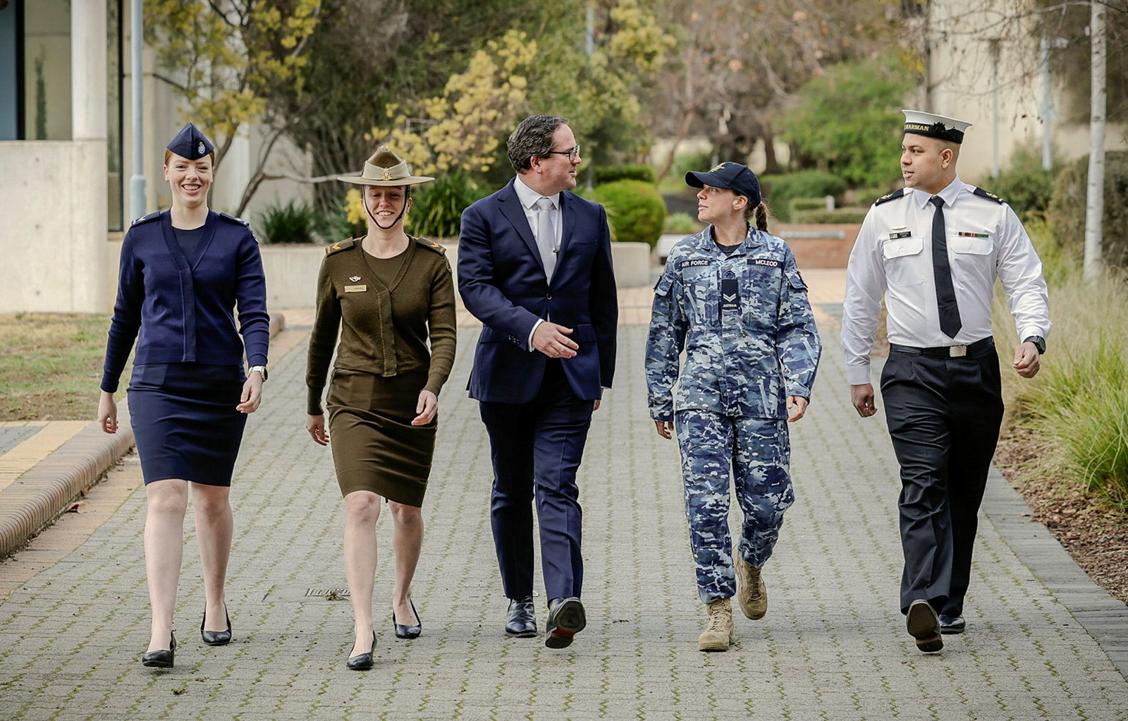 a man in a suit with ADF recruits