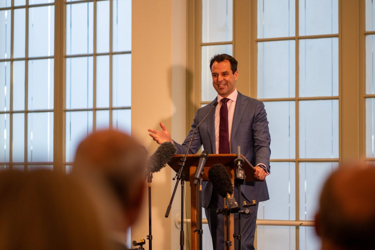 man addressing a meeting from a lectern