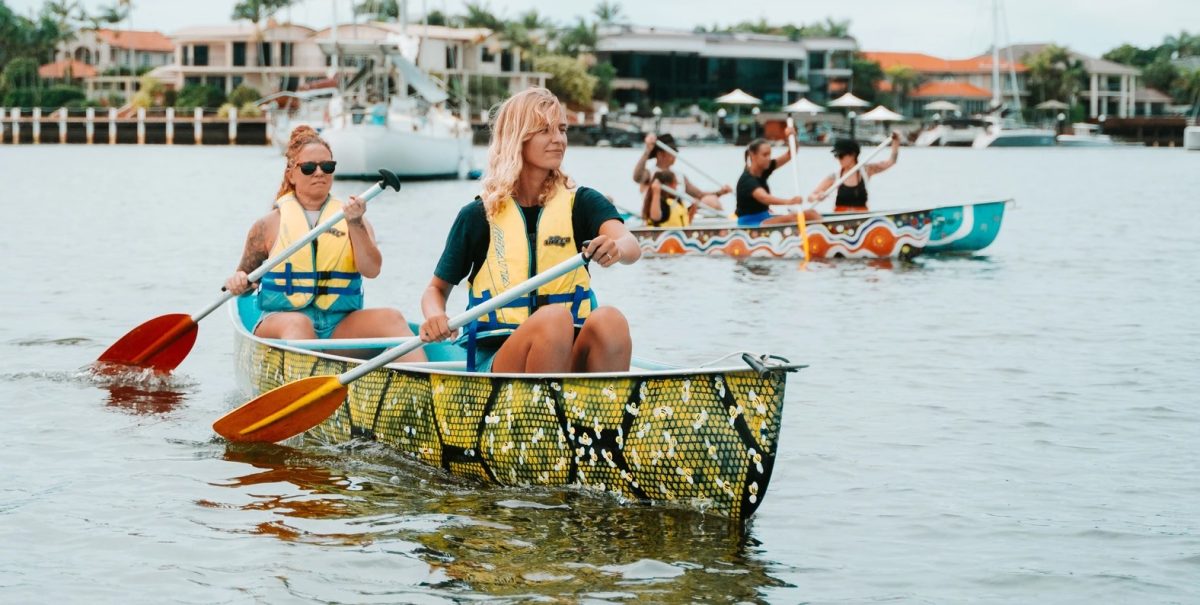 two young women in canoes on a river