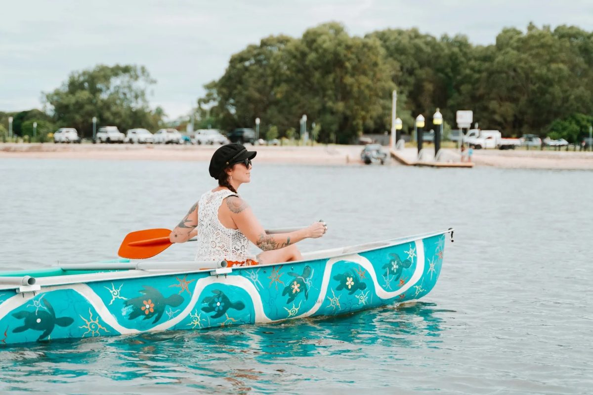 A woman paddling a canoe on a river