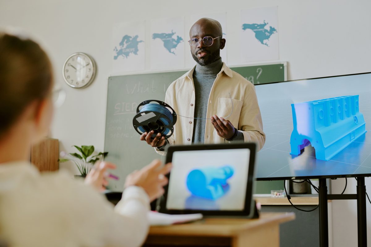 Male teacher and a female student in a classroom