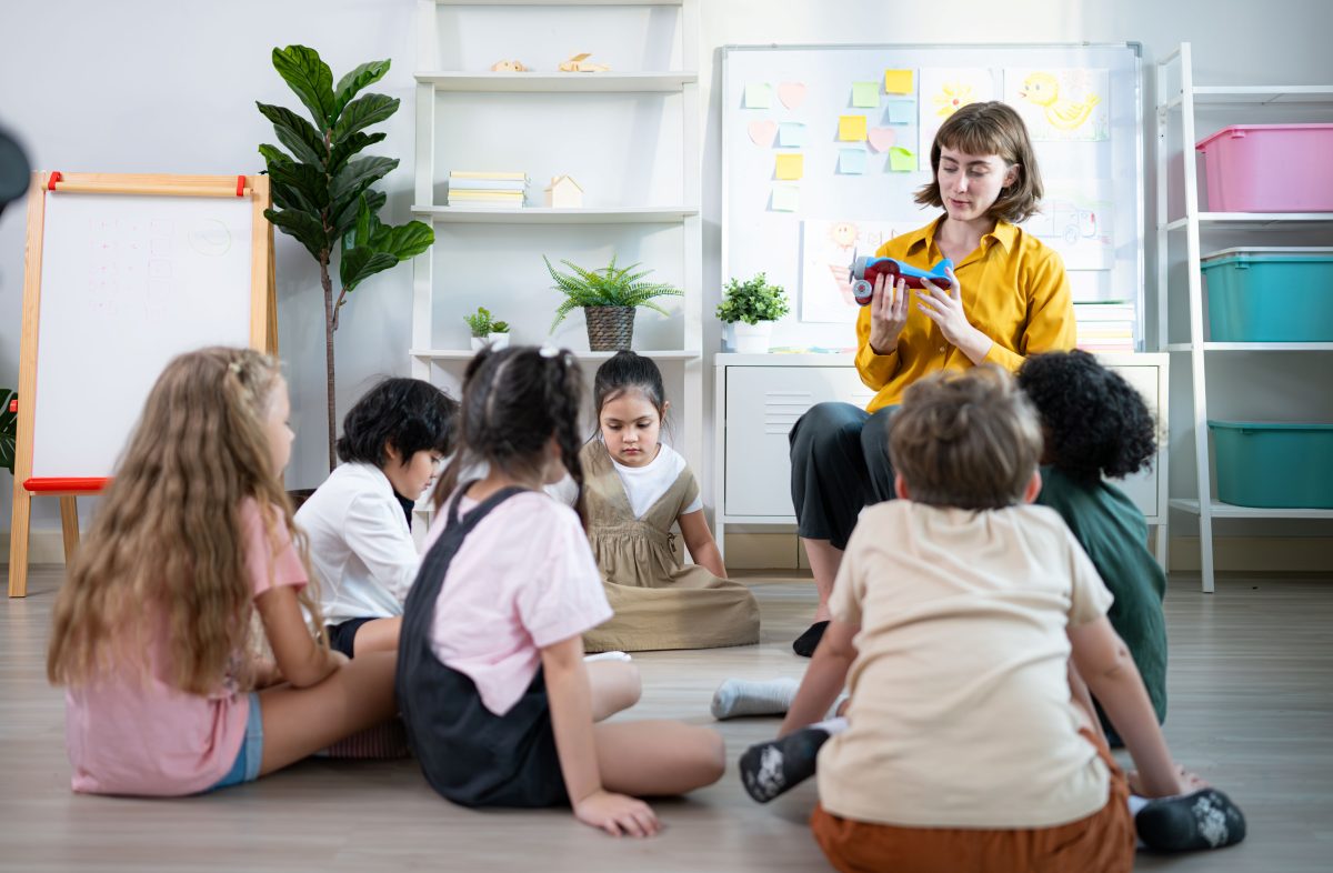 Teacher reading to kids in a classroom