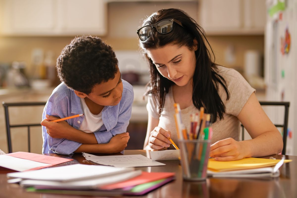 a young woman and a child doing schoolwork