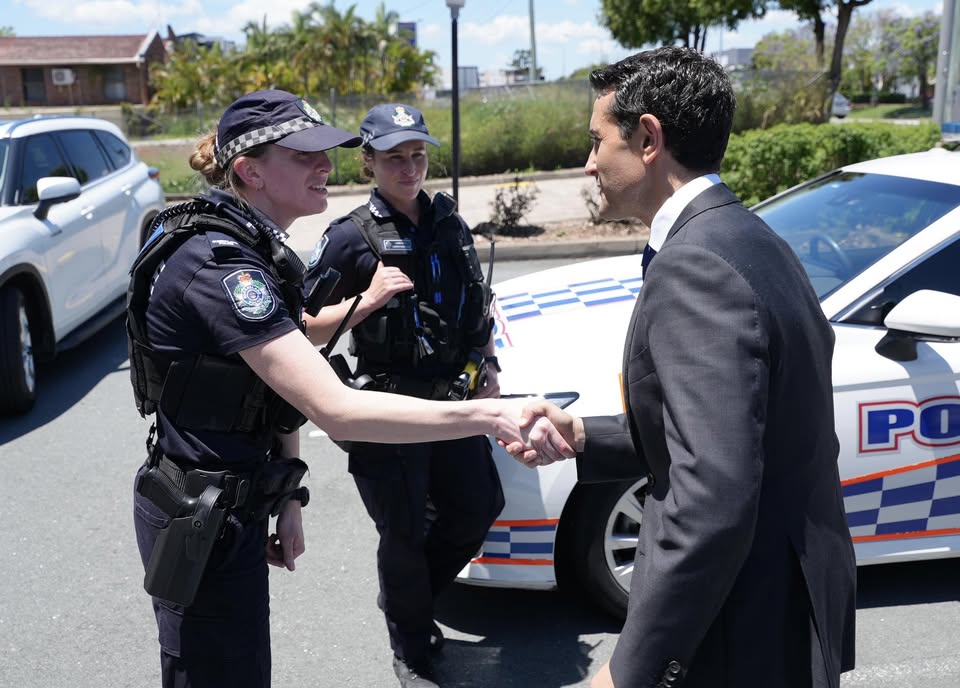 man shaking hands with a policewoman